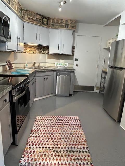 kitchen featuring gray cabinetry, sink, and stainless steel appliances