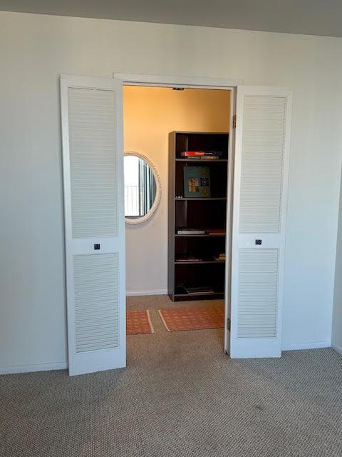 interior space featuring dark colored carpet