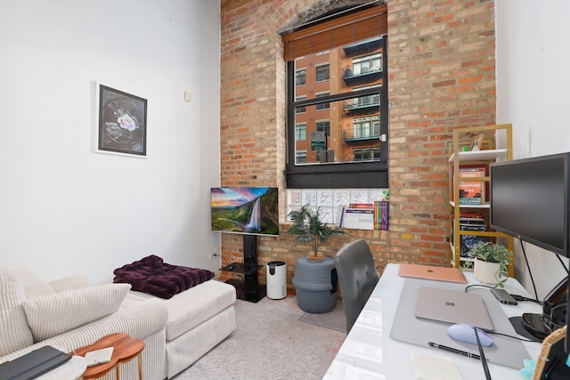 office space featuring carpet flooring and brick wall