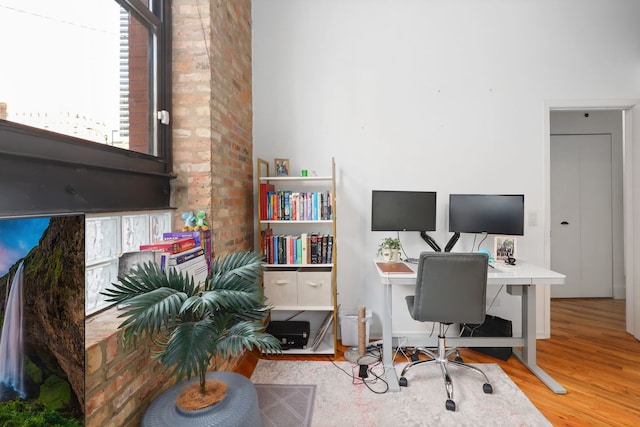 home office with light hardwood / wood-style floors and plenty of natural light