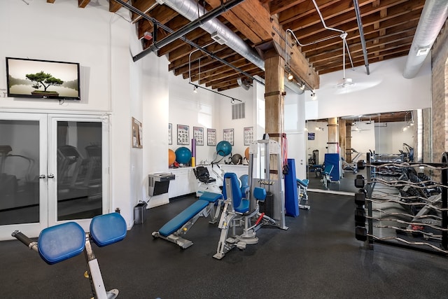 exercise room featuring a high ceiling