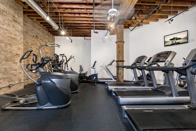 exercise room with brick wall