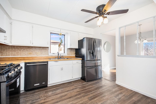 kitchen featuring white cabinets, appliances with stainless steel finishes, dark wood-type flooring, decorative backsplash, and sink