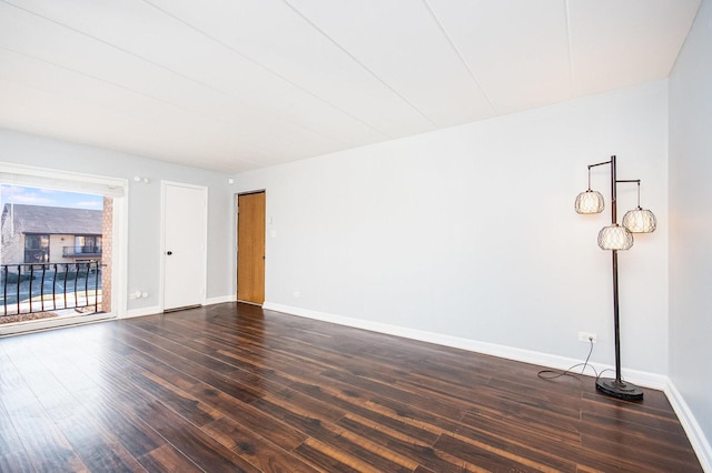 unfurnished room featuring dark hardwood / wood-style floors and plenty of natural light