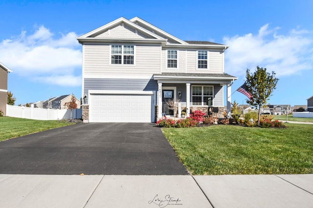 view of front facade featuring covered porch, a garage, and a front lawn