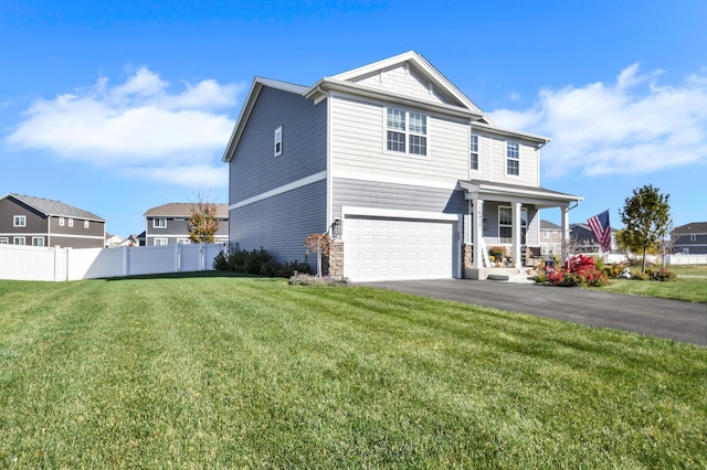 view of property with a garage and a front lawn