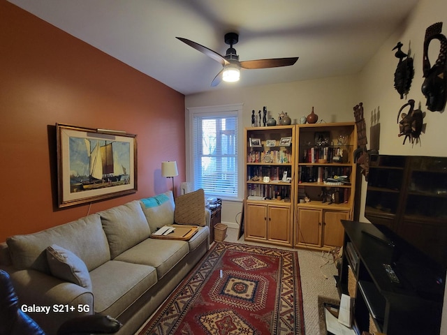 living room featuring ceiling fan and light carpet