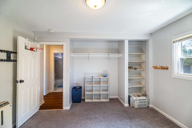 unfurnished bedroom with carpet flooring, a textured ceiling, and a closet