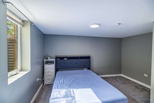 bedroom with dark colored carpet