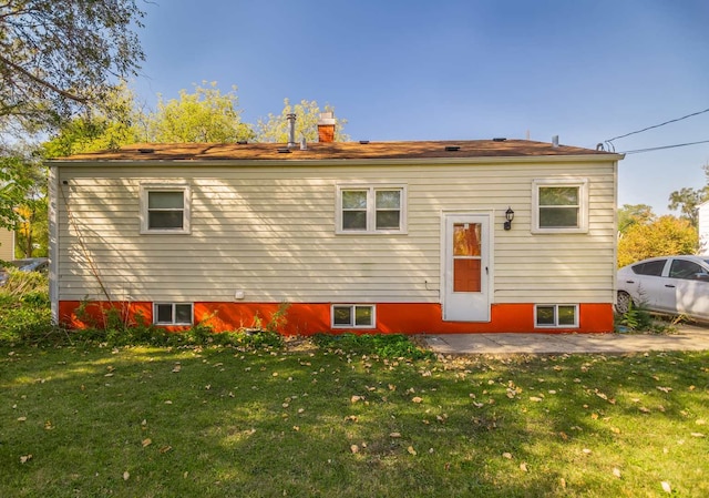 back of house with a yard and a patio area