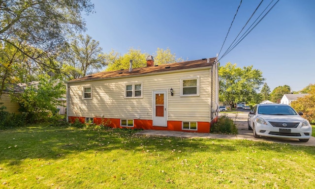 back of property featuring a yard