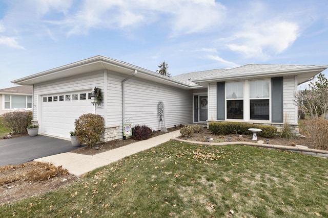 ranch-style home with a front lawn and a garage