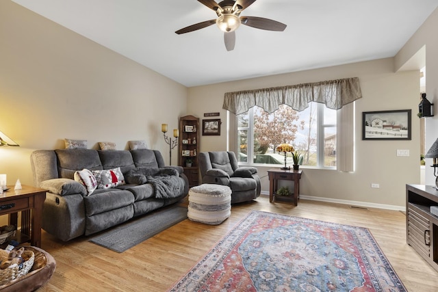 living room featuring light hardwood / wood-style floors and ceiling fan