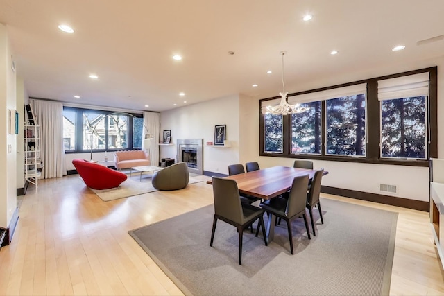 dining room featuring light hardwood / wood-style flooring and a chandelier