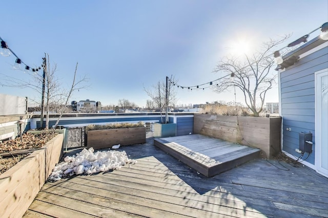 wooden deck featuring a swimming pool