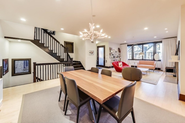 dining area with an inviting chandelier and light wood-type flooring