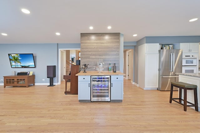 3430 Sandstone Ct, Lake In The Hills, IL 60156 - kitchen featuring beverage cooler, freestanding refrigerator, baseboards, light countertops, and recessed lighting