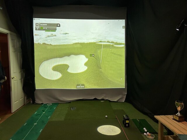3430 Sandstone Ct, Lake In The Hills, IL 60156 - bathroom featuring golf simulator and an area to practice putting