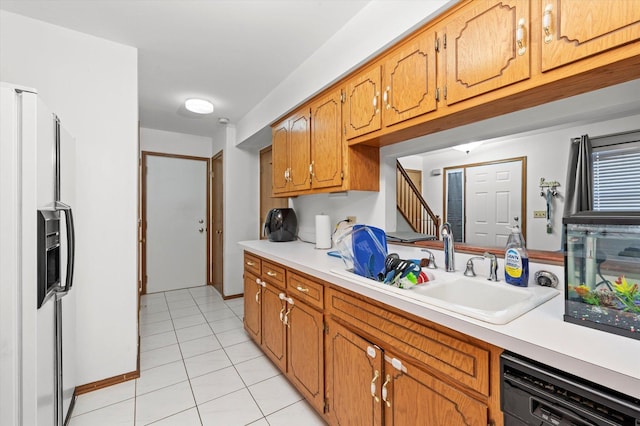 kitchen featuring light tile patterned floors, sink, white fridge with ice dispenser, and black dishwasher