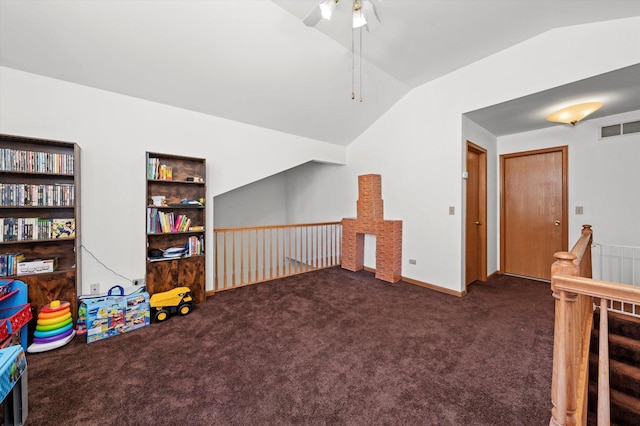 interior space featuring lofted ceiling, ceiling fan, built in features, and dark colored carpet