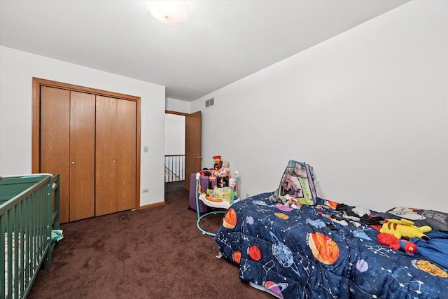 bedroom featuring a closet and dark colored carpet