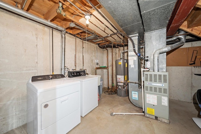 basement featuring water heater and washing machine and clothes dryer