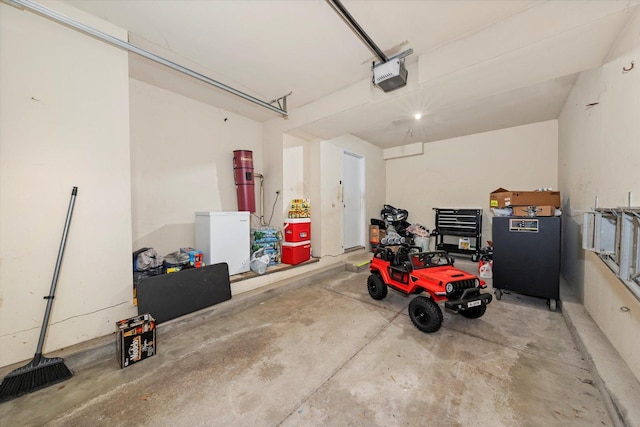 garage with refrigerator and a garage door opener