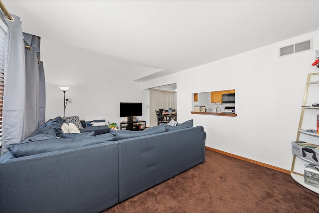 living room with dark colored carpet