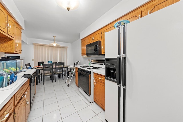 kitchen featuring light tile patterned floors and white appliances