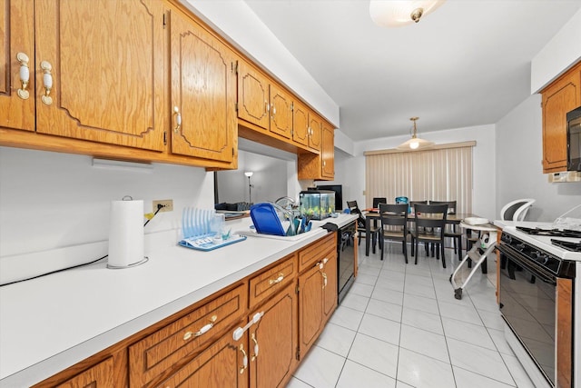 kitchen with light tile patterned floors and range with gas cooktop