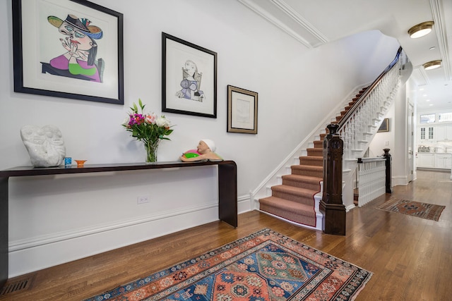 entryway with dark hardwood / wood-style flooring and ornamental molding