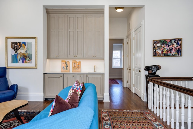 living room with dark hardwood / wood-style floors and sink