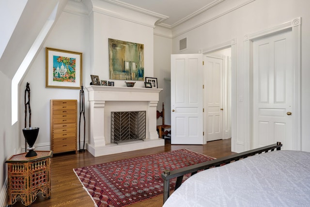 bedroom with dark hardwood / wood-style floors, a closet, and ornamental molding