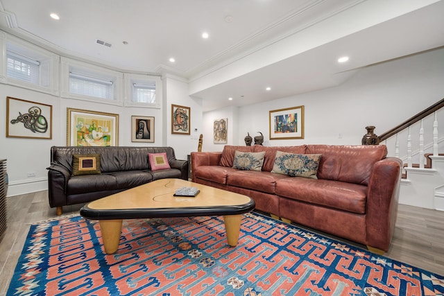 living room with hardwood / wood-style flooring and crown molding