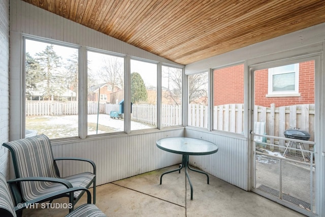 sunroom featuring lofted ceiling and wood ceiling