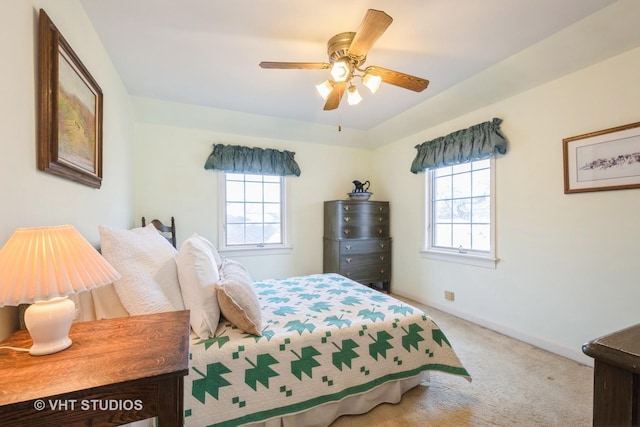 bedroom with ceiling fan and light carpet