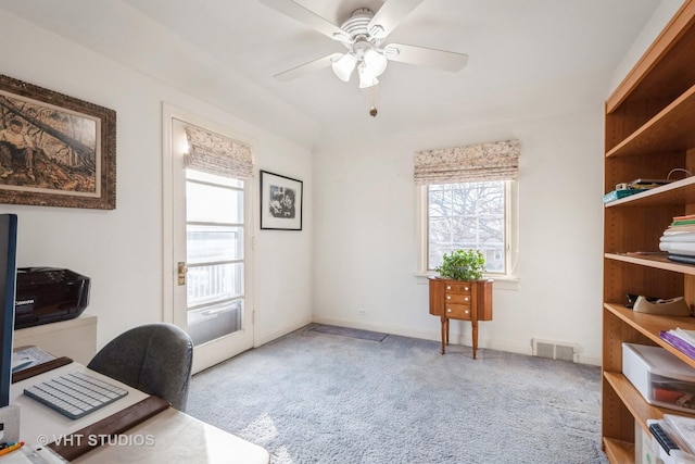 carpeted office featuring ceiling fan