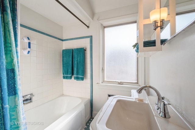 bathroom with sink and shower / bath combo with shower curtain