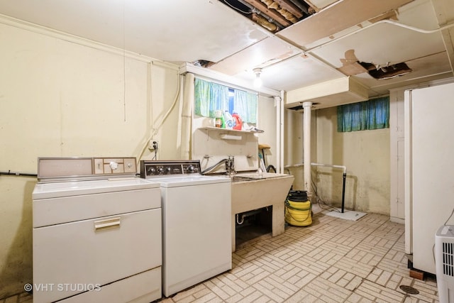 clothes washing area with washing machine and dryer