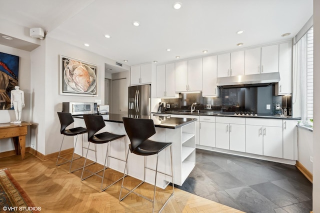 kitchen with stainless steel fridge with ice dispenser and white cabinets