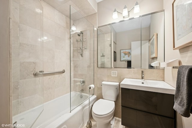 full bathroom featuring tiled shower / bath combo, backsplash, toilet, vanity, and tile walls