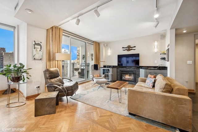 living room featuring light parquet flooring and rail lighting