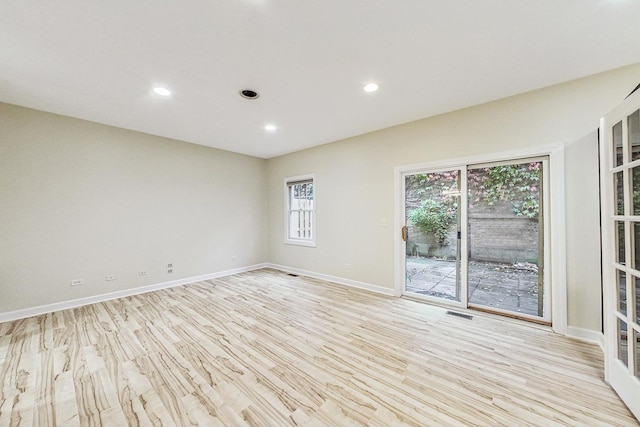 spare room featuring light hardwood / wood-style floors