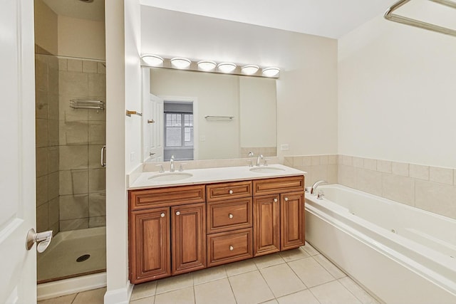 bathroom featuring tile patterned floors, vanity, and shower with separate bathtub