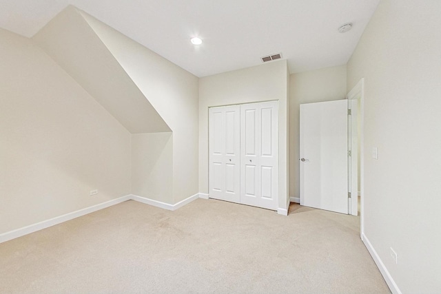 additional living space featuring light colored carpet