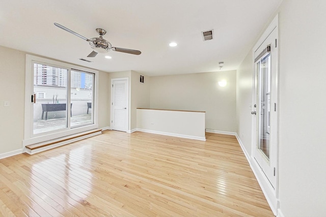 spare room with ceiling fan and light hardwood / wood-style floors