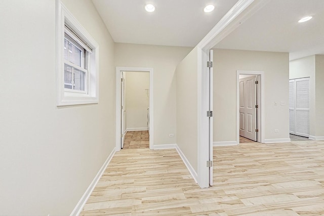 corridor with light wood-type flooring