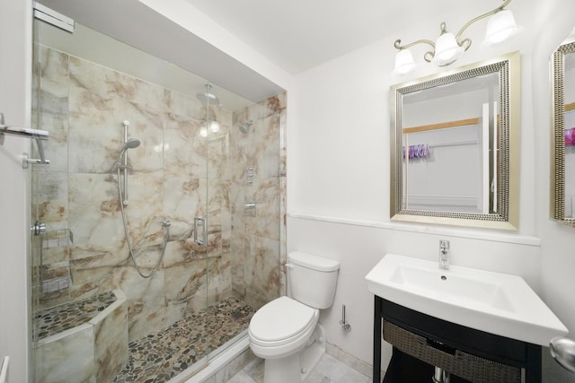 bathroom with vanity, toilet, and an enclosed shower