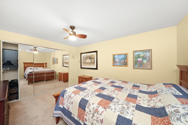 carpeted bedroom featuring ceiling fan and a closet