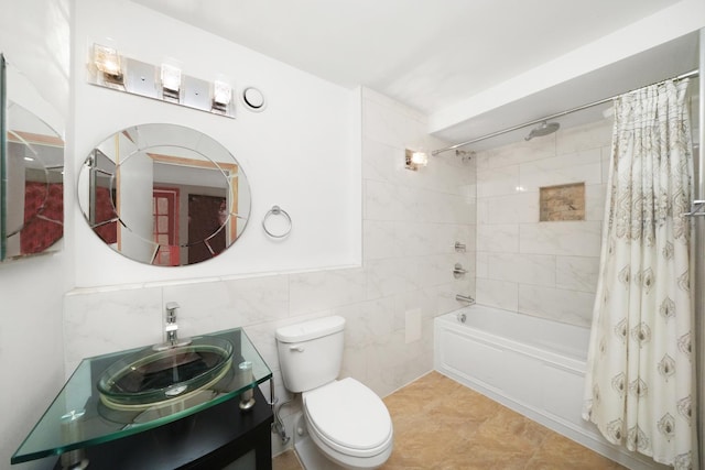 full bathroom featuring vanity, shower / bath combo with shower curtain, tile walls, tile patterned flooring, and toilet